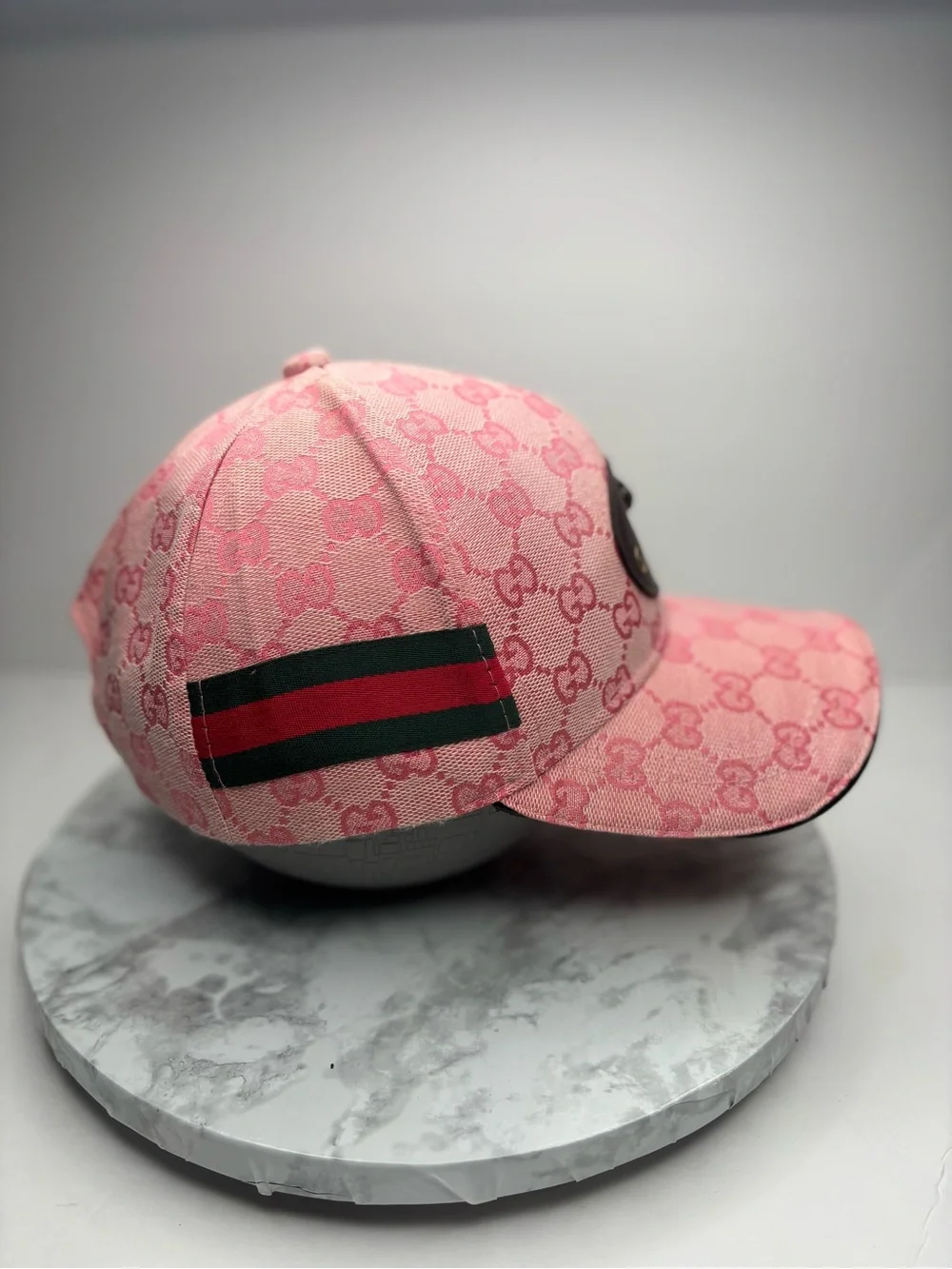 Gucci baseball cap featuring a pink GG monogram canvas and a leather patch